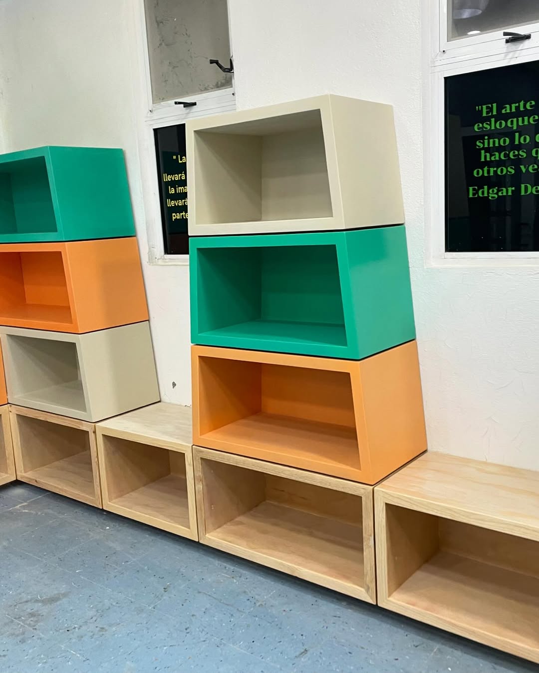 Modular school library shelving in natural oak with colorful lacquered inserts